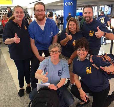 AT THE AIRPORT – PEF nurses pose for a photo before boarding a plane to San Juan. The Hurricane Maria volunteers are Carolyn Cole, Douglas Massey, Susan Williams, Justin Farrier (kneeling) Patricia Trowbridge and Llamara Padro-Milano. 